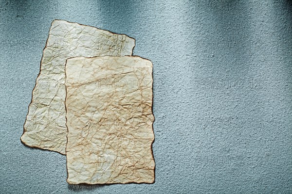 Aged blank sheets of paper on grey background