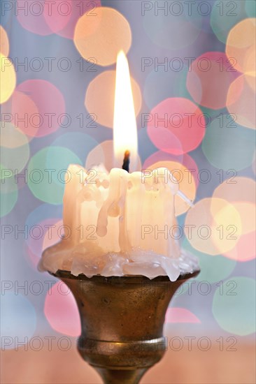 Very close-up on old candle on the background of bokeh