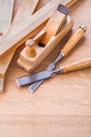 Chisel and plane on wooden board