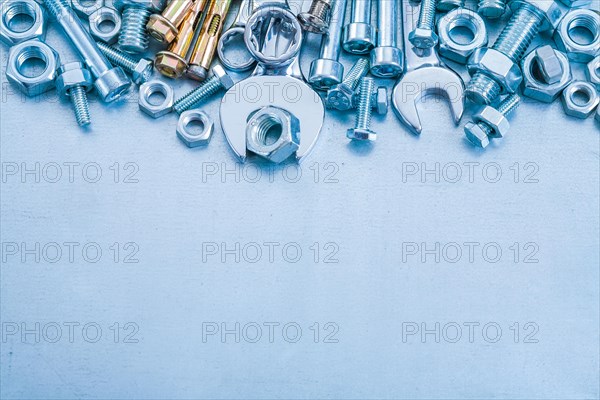 Anchor bolt Bolt nuts Hook spanner and flat spanner on metallic background Construction concept