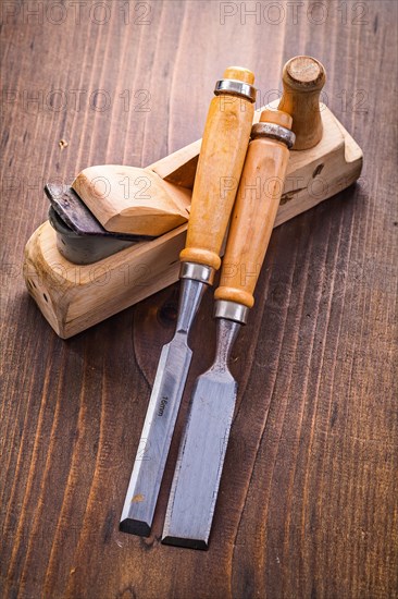 Plane and chisel on an old wooden board