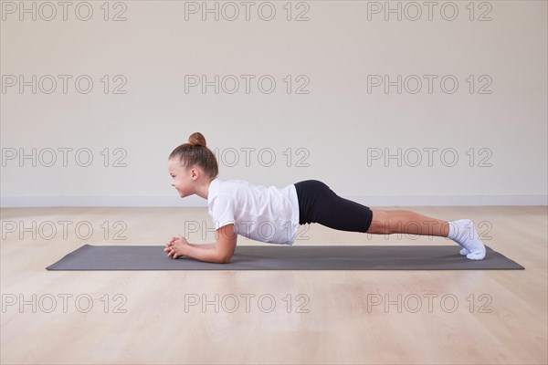 Little girl performs exercises in a gymnastics sports class. The concept of sports