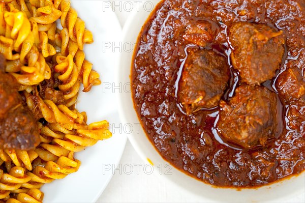 Fusilli pasta al dente with neapolitan style ragu meat sauce very different from bolognese style