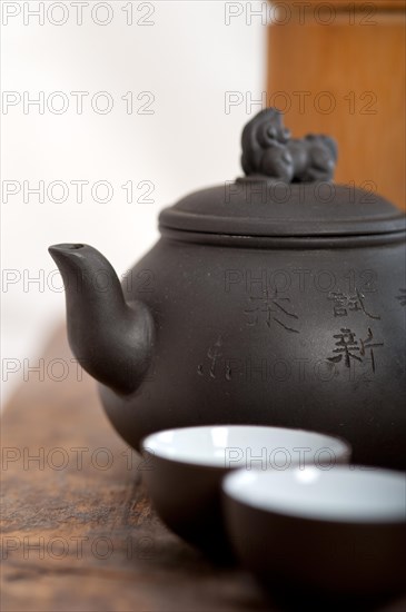 Chinese style pot and cups over old wood table