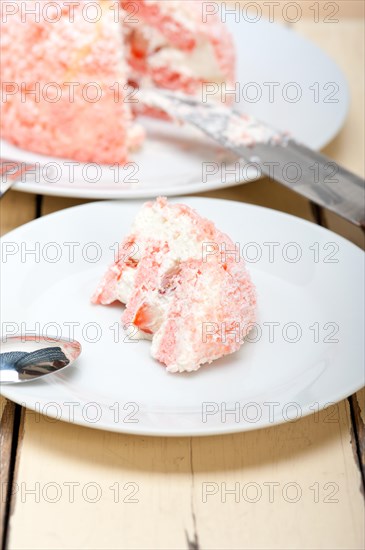 Fresh pink strawberry and whipped cream dessert macro close up