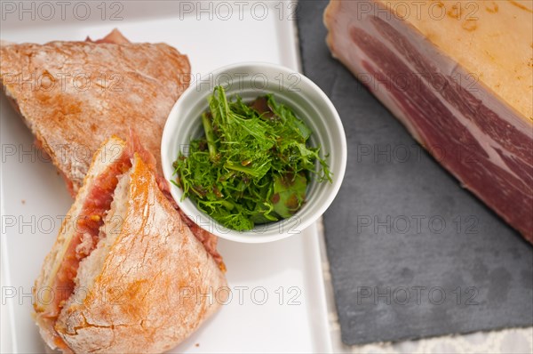 Italian ciabatta panini sandwich with parma ham and tomato