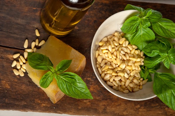 Italian basil pesto ingredients over old wood macro