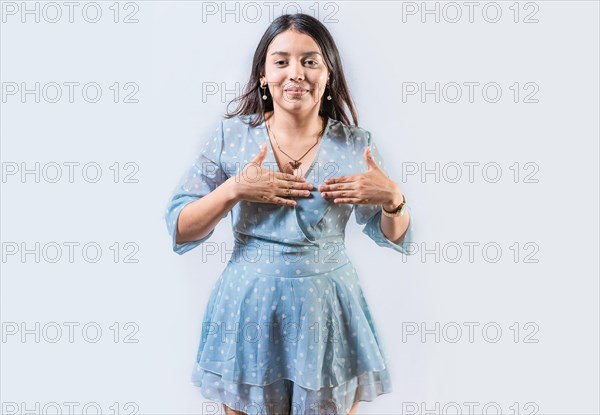 Girl gesturing the word THANKFUL in sign language. Person gesturing GRATEFUL in sign language