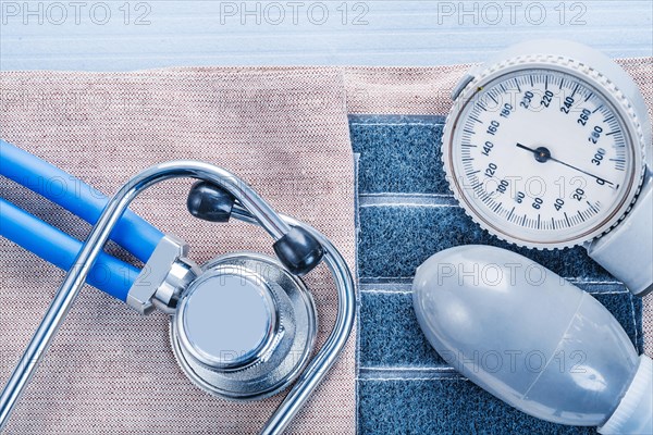 Blood pressure monitor and stethoscope on blue background medical concept