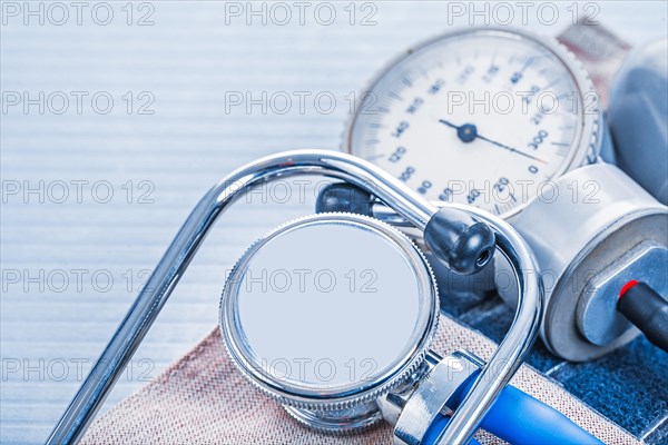 Stethoscope on blood pressure monitor on blue background medical concept