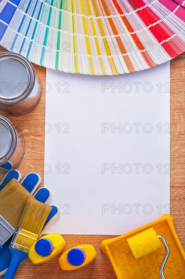 Group of colour tools and Pantone colour palette guide on sheet of paper construction concept