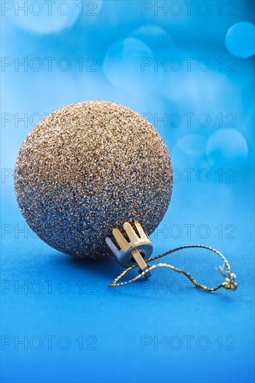 Golden Christmas bauble on a beautiful blue background