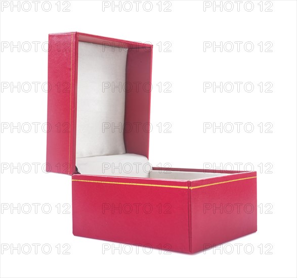 Opened gift box covered with red soft textured leather against a white background