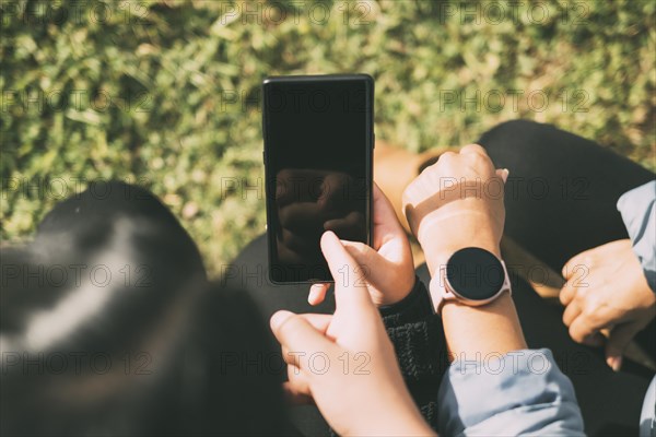 View of hand touching smart phone and smart watch screen