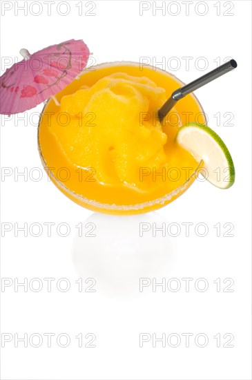 Frozen mango margarita daiquiri with lime black straw and pink umbrella isolated on white background