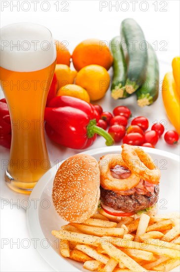 Classic american hamburger sandwich with onion rings and french fries