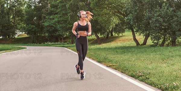 Fitness girl in sportswear runs through the evening sunny park. Healthy lifestyle. Mixed media