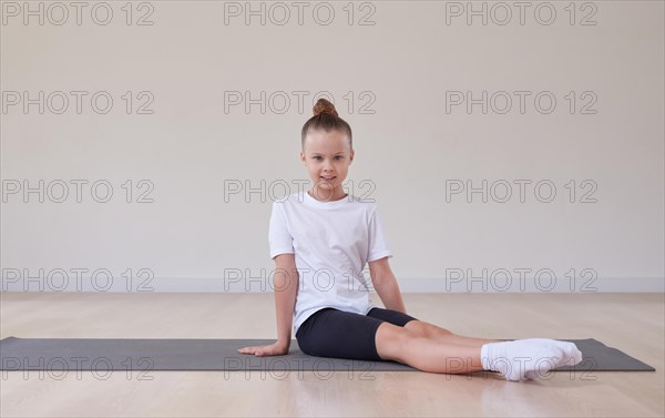 Little girl performs exercises in a gymnastics sports class. The concept of sports