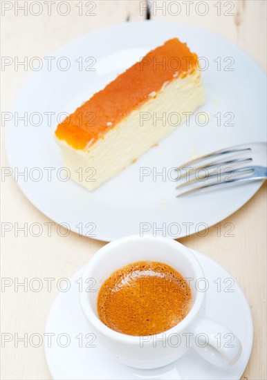 Italian espresso coffee and cheese cake over white wood table