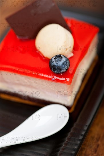 Fresh strawberry yogurt mousse with macaroon and blueberry on top