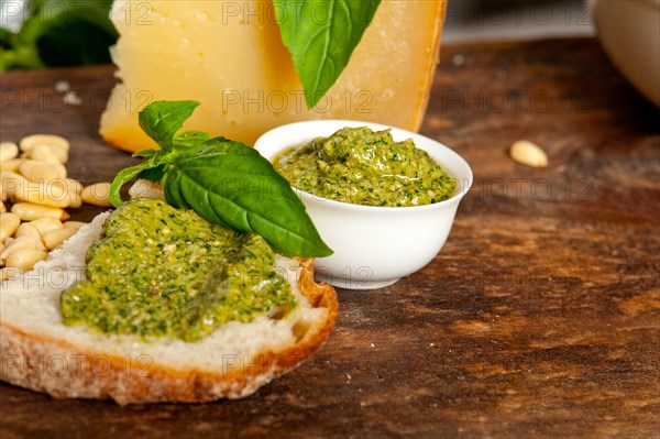 Italian basil pesto bruschetta ingredients over old wood macro