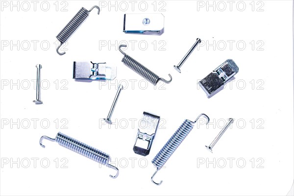 Repair kit of springs and clips for parking brake pads on white isolated background