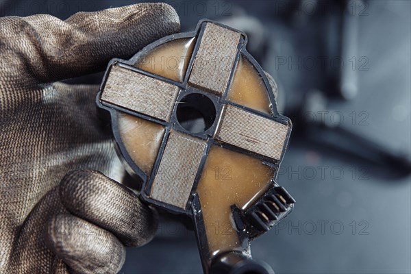 Engine ignition coil in hand of auto mechanic