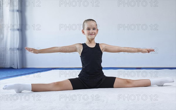 Image of a little girl in the gym. Gymnastics concept. Mixed media