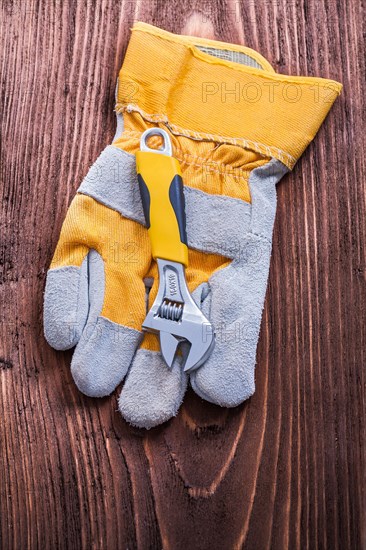 Adjustable spanner and protective glove for the concept of wood panel maintenance