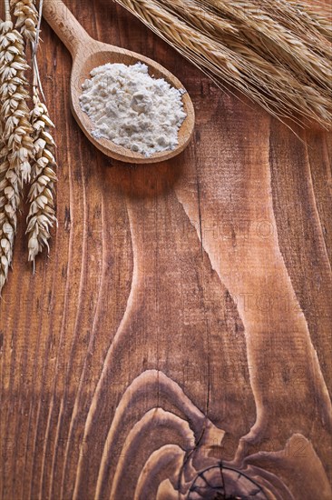 Copyspace image Wooden spoon with ears of wheat on old wooden boards