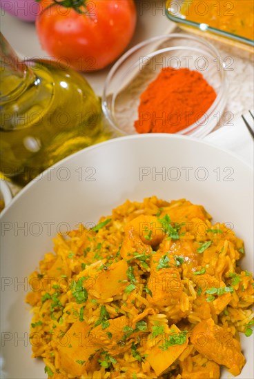 Fresh home made curry beef rice and potatoes with ingredients around composition