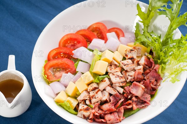 Fresh classic caesar salad over blue tablecloth close up