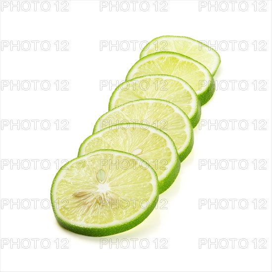Green fresh lime slices isolated over white background