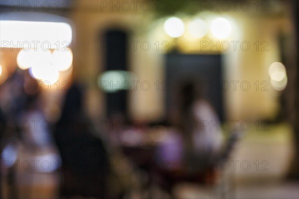 Illuminated street cafe at night