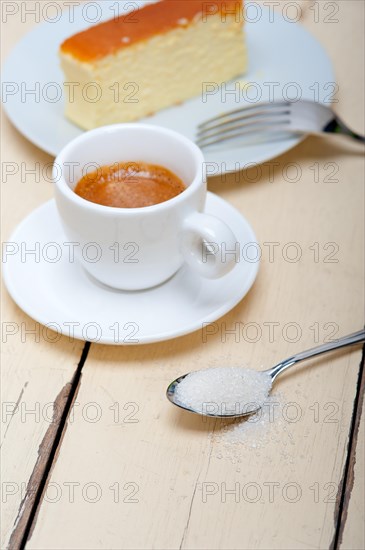 Italian espresso coffee and cheese cake over white wood table