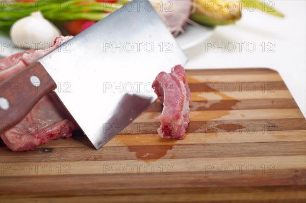 Fresh pork ribs with vegetables and herbs ready to cook