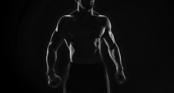 Noname image of a kickboxer on a dark background. The concept of mixed martial arts. MMA