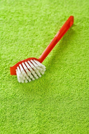 Red brush on green towel