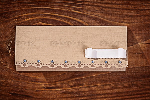 Envelope for invitation on wooden table
