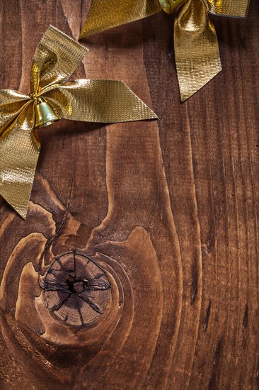 Golden bows on an old wooden board