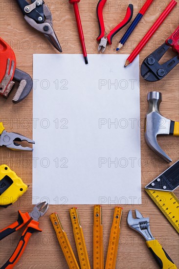 Organised copying area white blank sheet of paper and tools on wooden board