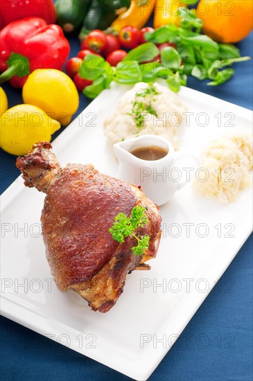 Original German BBQ pork knuckle served with mashed potatoes and sauerkraut