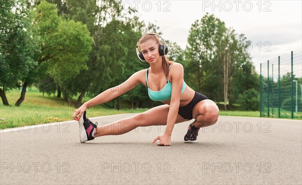 Charming girl does a workout in the park. The concept of a healthy lifestyle. Sports Equipment. Fitness style advertisement. Mixed media
