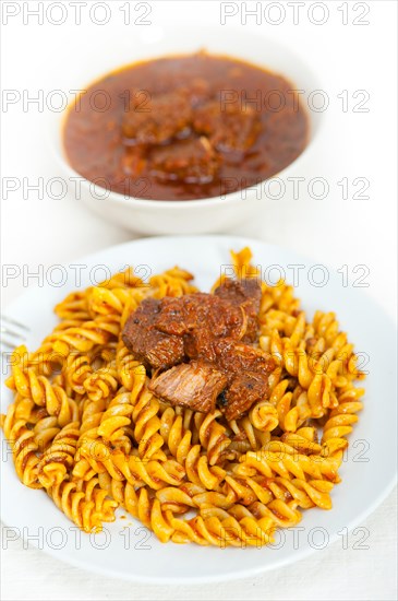 Fusilli pasta al dente with neapolitan style ragu meat sauce very different from bolognese style