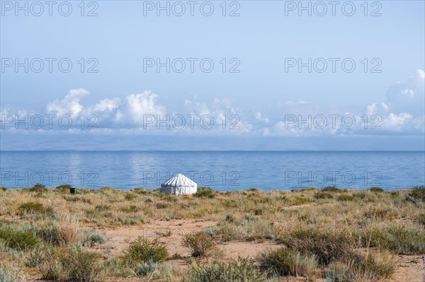 White yurt on the lakeshore