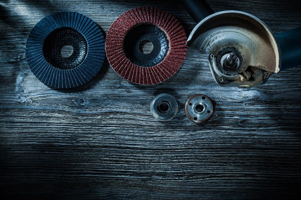 Hand angle grinder radial polishing discs on vintage wooden board