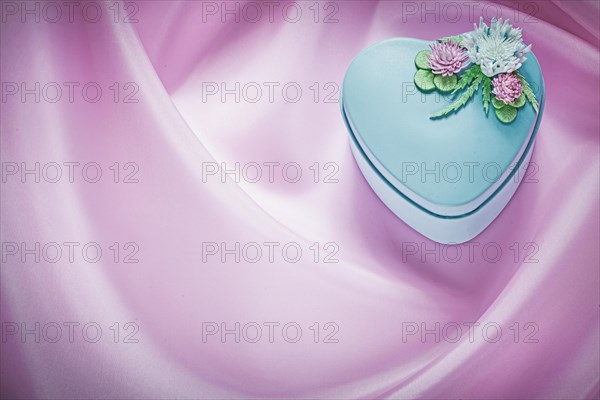 Blue present box on pink fabric background holidays concept