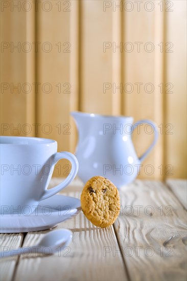 Blue coffee cup and jug on a white table
