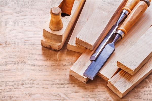 Chisel on boards and wooden plane on wooden board