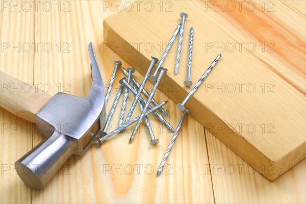 Claw hammer with nails and wood on the table